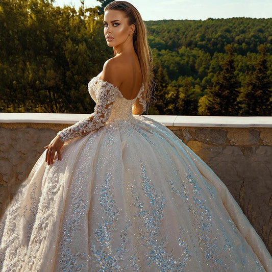 Shiny Sequin Long Sleeve Ball Gown Wedding Dress with Fitted Waist & Backless Design.