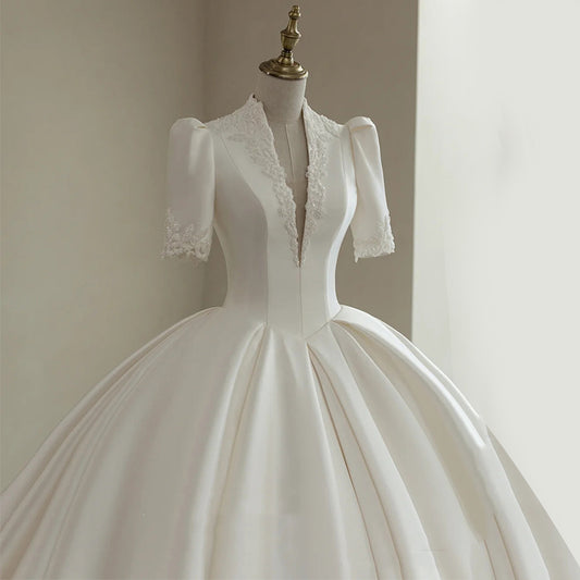 Royal Satin Ball Gown Wedding Dress with Structured Puff Sleeves.