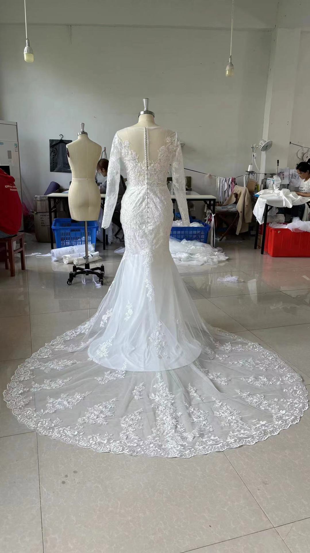 Long Sleeve Lace Mermaid Wedding Dress with Deep V-Neck and Train.