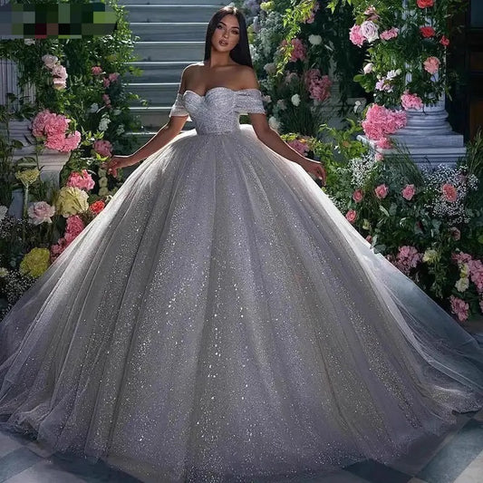 Off-Shoulder White Sequined Ball Gown Wedding Dress with Full Tulle Skirt.