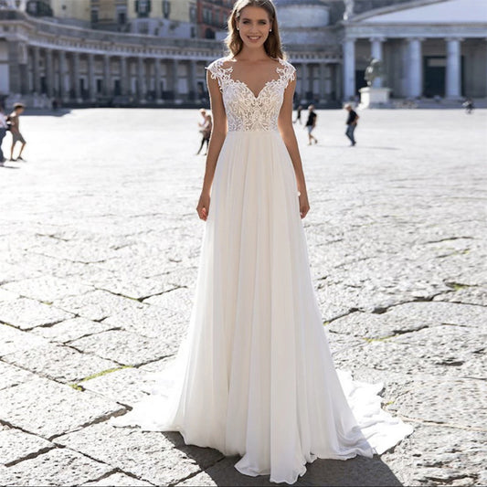 Ivory A – Line Chiffon Wedding Dress with V – Neck and Long Sleeves. luxury bridal gown by Bridal Boutique