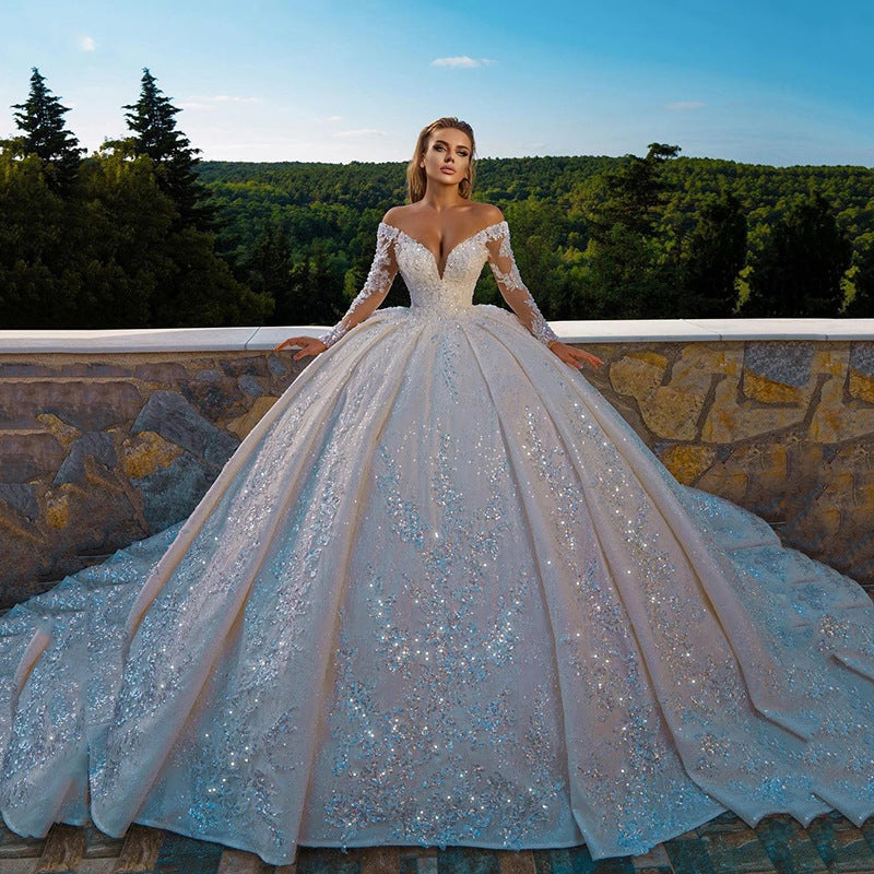 Shiny Sequin Long Sleeve Ball Gown Wedding Dress with Fitted Waist & Backless Design.