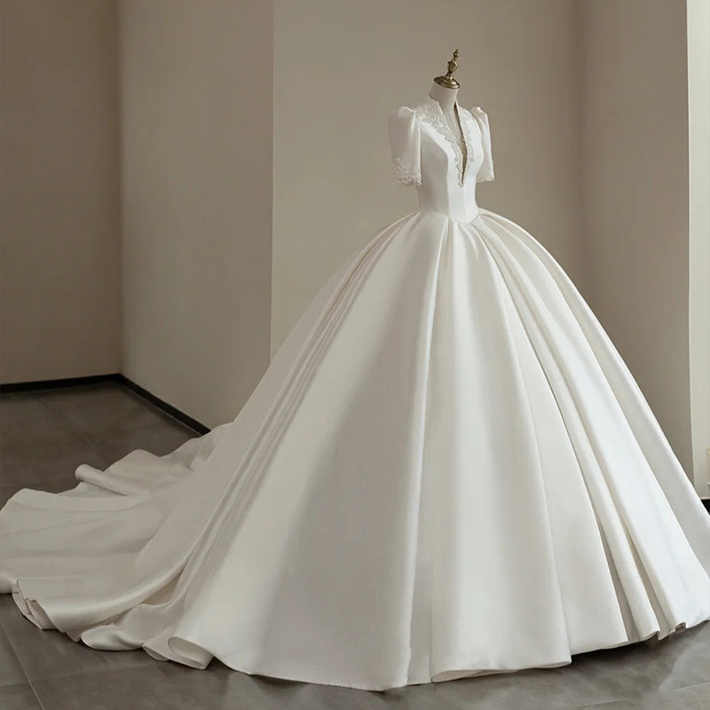 Royal Satin Ball Gown Wedding Dress with Structured Puff Sleeves.