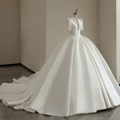Royal Satin Ball Gown Wedding Dress with Structured Puff Sleeves.