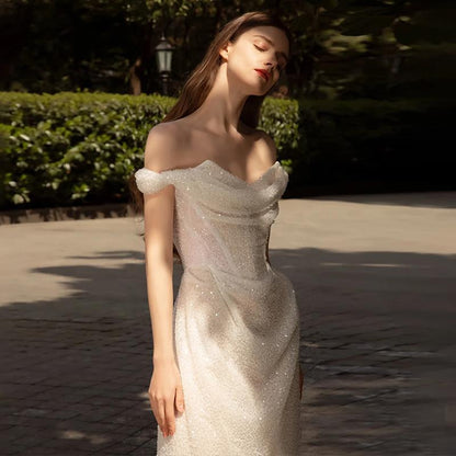 Romantic Off-the-Shoulder Lace Sheath Wedding Dress with Draped Sleeves.