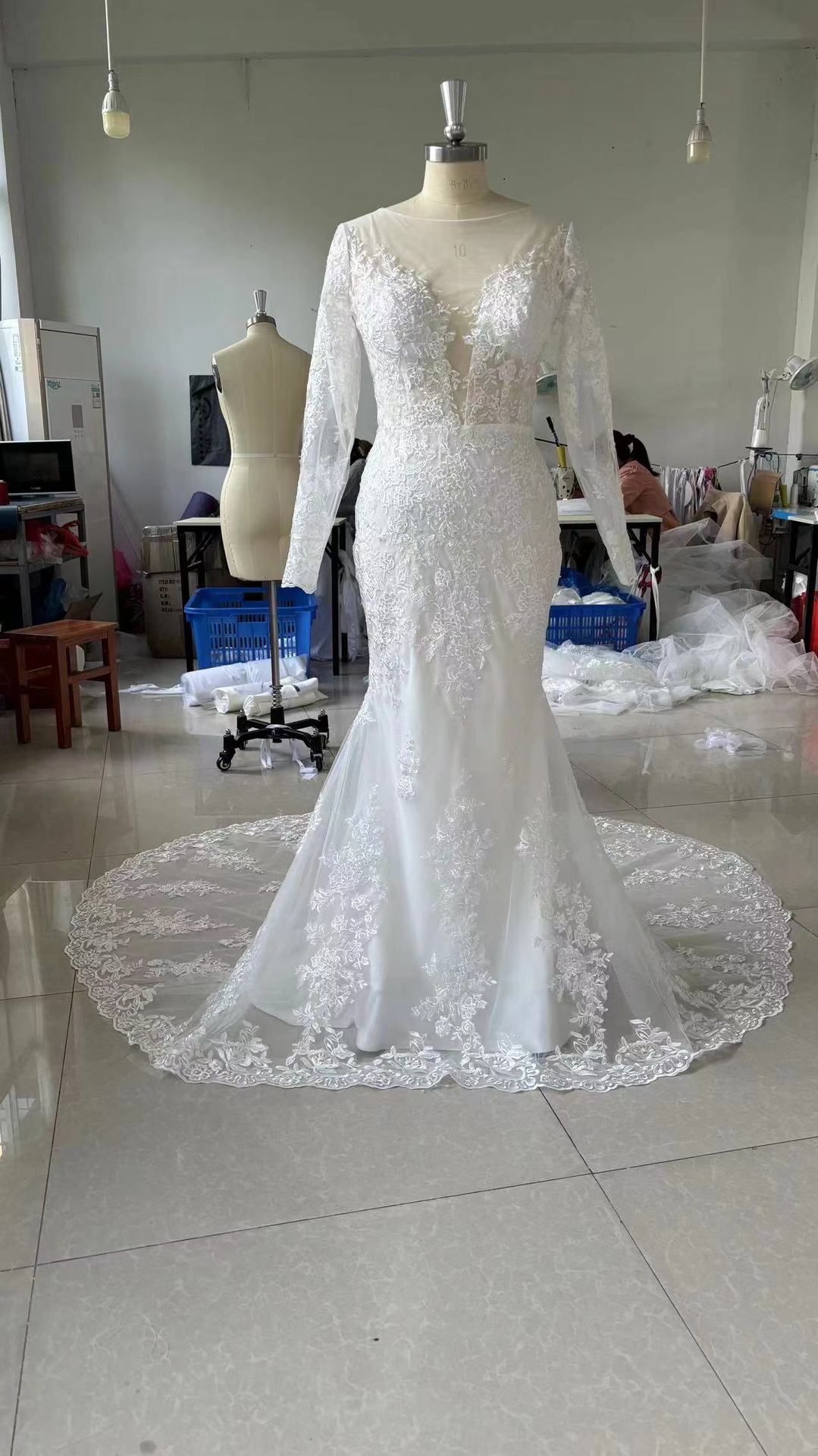 Long Sleeve Lace Mermaid Wedding Dress with Deep V-Neck and Train.