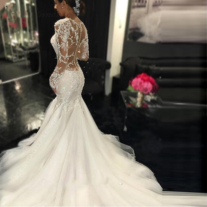 Long Sleeve Lace Mermaid Wedding Dress with Dramatic Cathedral Train.