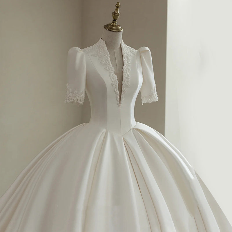 Royal Satin Ball Gown Wedding Dress with Structured Puff Sleeves.