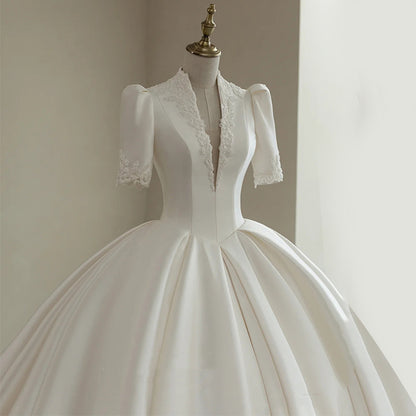 Royal Satin Ball Gown Wedding Dress with Structured Puff Sleeves.