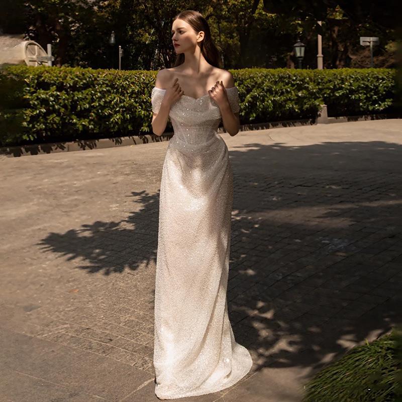 Romantic Off-the-Shoulder Lace Sheath Wedding Dress with Draped Sleeves.