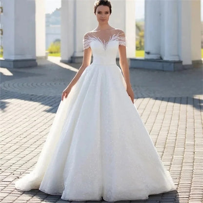 Off-Shoulder White Lace Wedding Dress with Train and Veil.