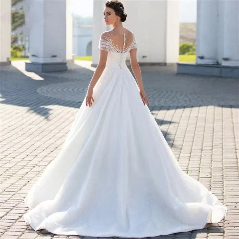 Off-Shoulder White Lace Wedding Dress with Train and Veil.