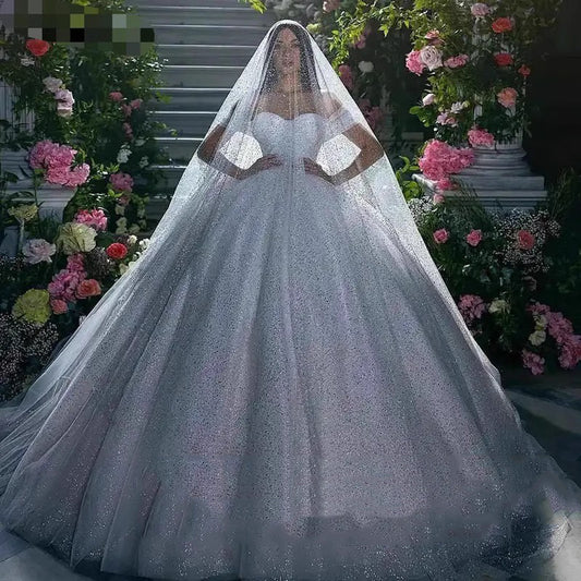 Off-Shoulder White Sequined Ball Gown Wedding Dress with Full Tulle Skirt.