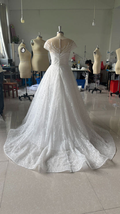 Off-Shoulder White Lace Wedding Dress with Train and Veil.