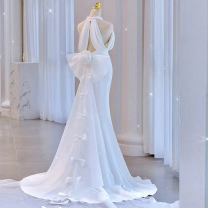 Modern Halter Satin Mermaid Wedding Dress with Dramatic Back Bow.